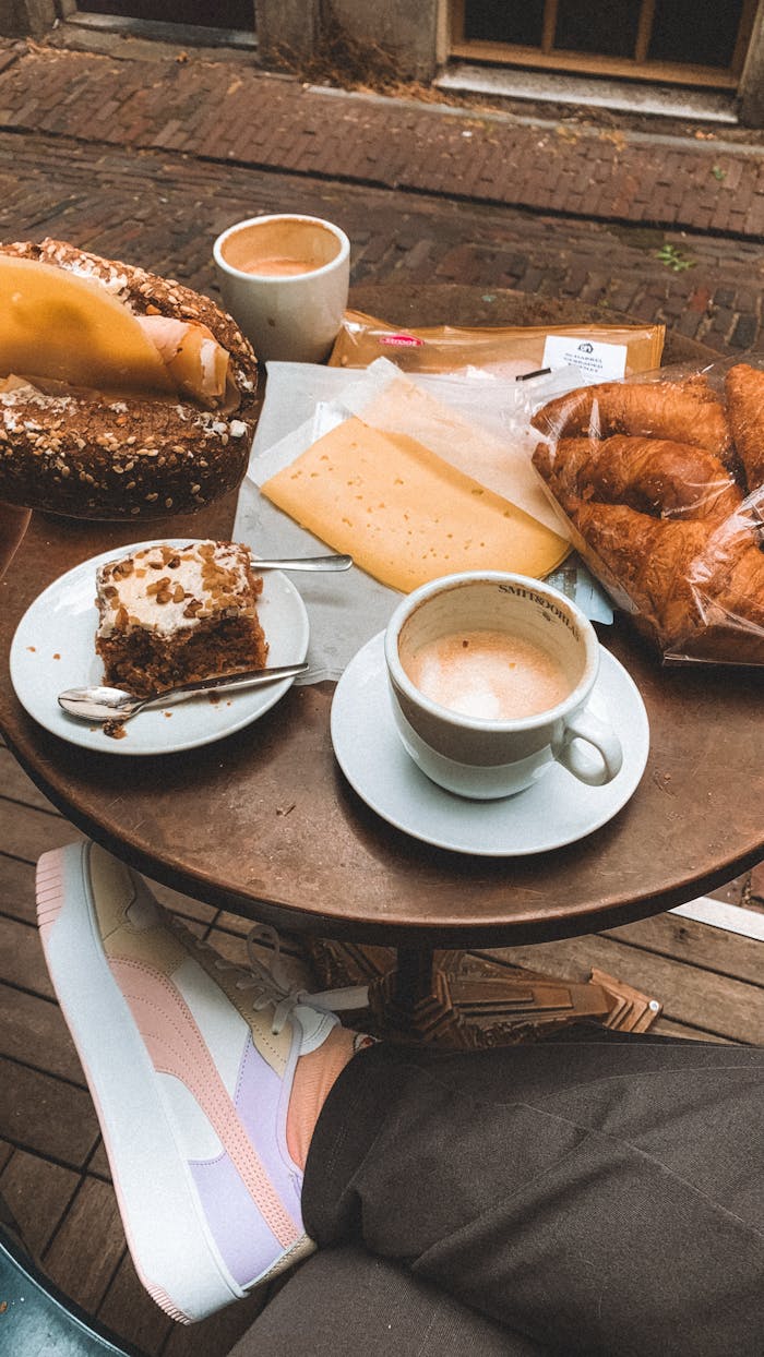 Enjoy a delightful outdoor breakfast in Tilburg with coffee, pastries, and cheese.